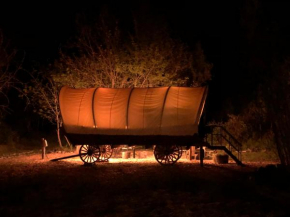 Cozy Wild West Covered Wagon next to River